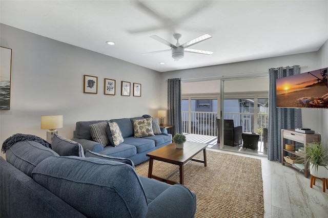 living room with hardwood / wood-style flooring and ceiling fan