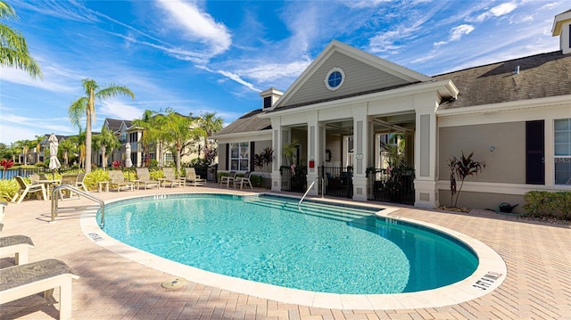 view of swimming pool featuring a patio area