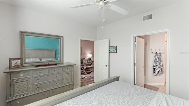 bedroom featuring ensuite bathroom, ceiling fan, and light tile patterned flooring