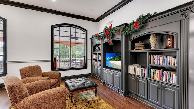 living area with crown molding and dark hardwood / wood-style floors