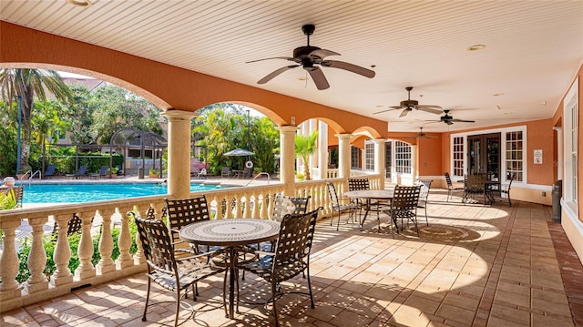 view of patio / terrace with ceiling fan and a community pool