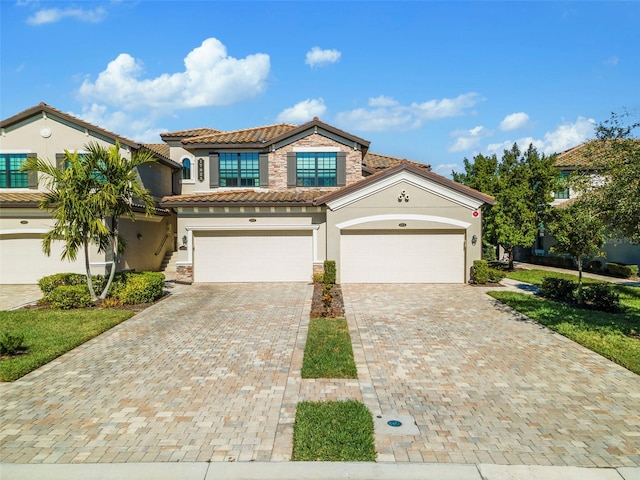 mediterranean / spanish-style house with a garage