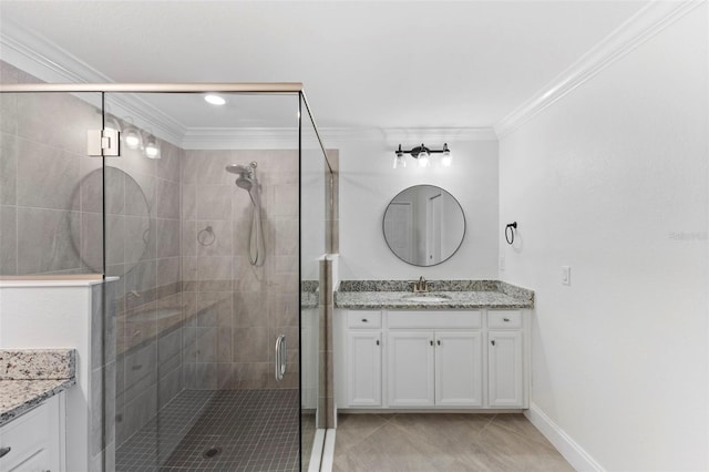 bathroom featuring vanity, tile patterned floors, a shower with door, and ornamental molding