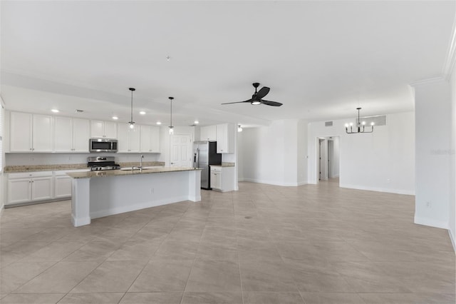 kitchen with decorative light fixtures, a center island with sink, white cabinets, ceiling fan with notable chandelier, and appliances with stainless steel finishes