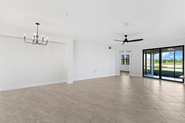 tiled spare room featuring crown molding and ceiling fan with notable chandelier