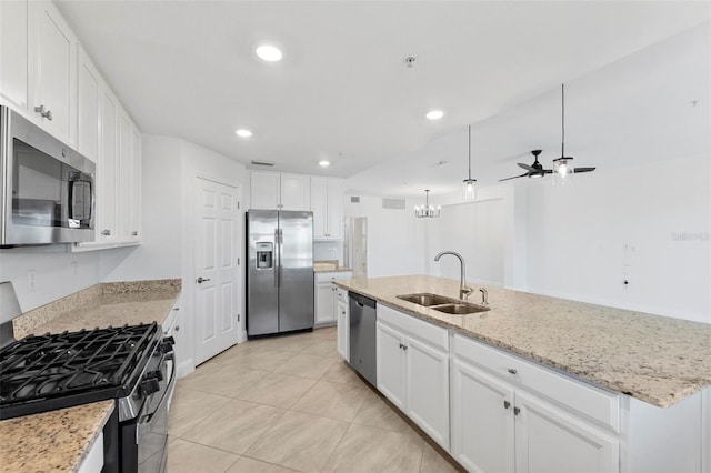 kitchen featuring appliances with stainless steel finishes, ceiling fan, a kitchen island with sink, sink, and white cabinetry