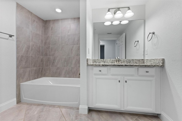 bathroom with washtub / shower combination, vanity, and tile patterned flooring