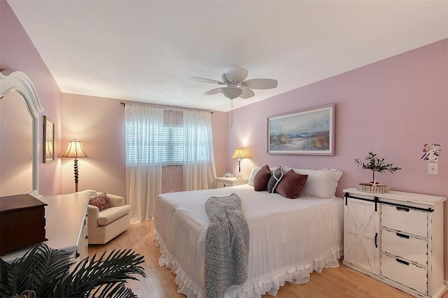 bedroom with light wood-type flooring and ceiling fan