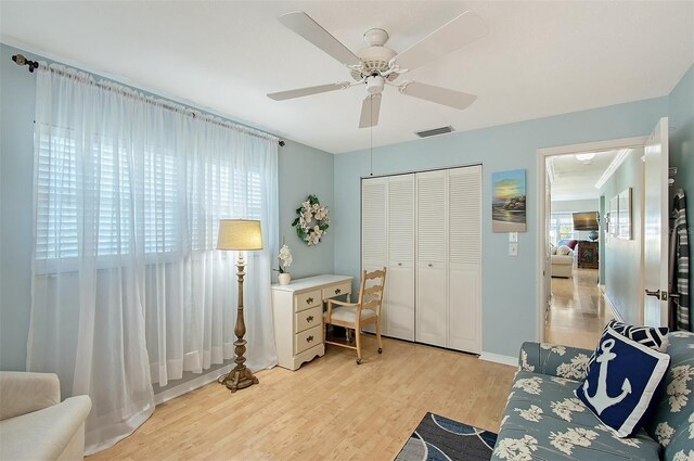 office space with ceiling fan and light hardwood / wood-style floors