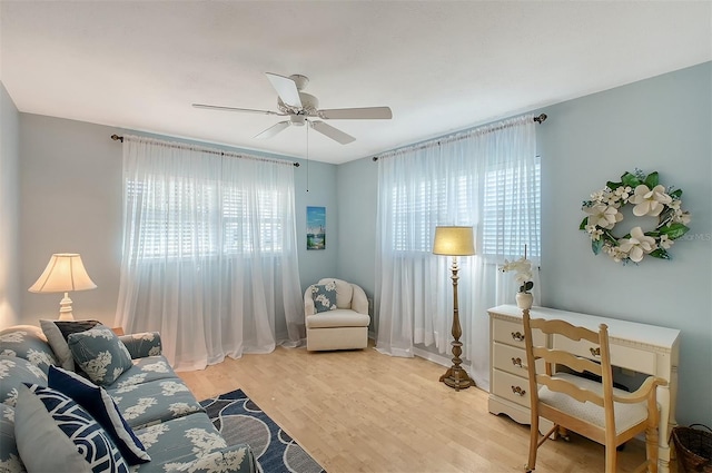 living area featuring ceiling fan and light wood-type flooring