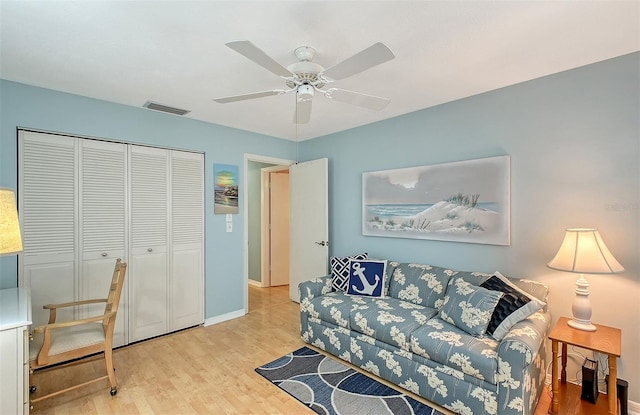 living room with ceiling fan and light wood-type flooring