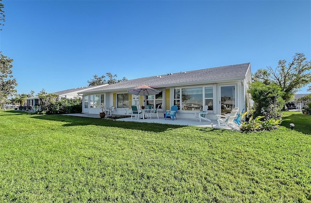 back of house featuring a yard and a patio