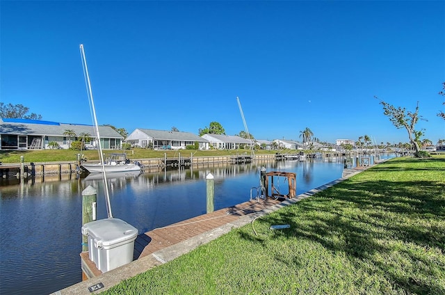 dock area with a water view and a yard