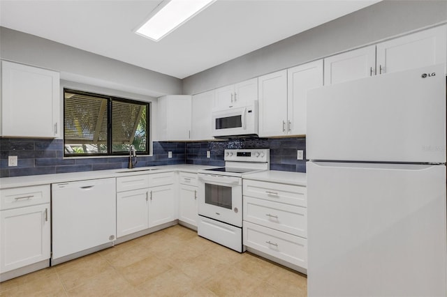 kitchen featuring white appliances, backsplash, white cabinetry, and sink