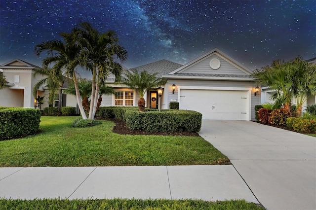 view of front of property featuring a garage and a front lawn