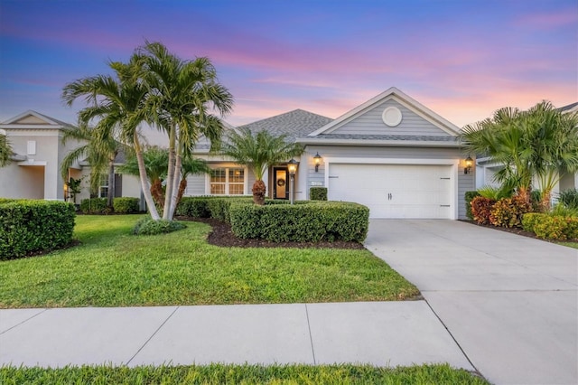 single story home featuring a lawn and a garage