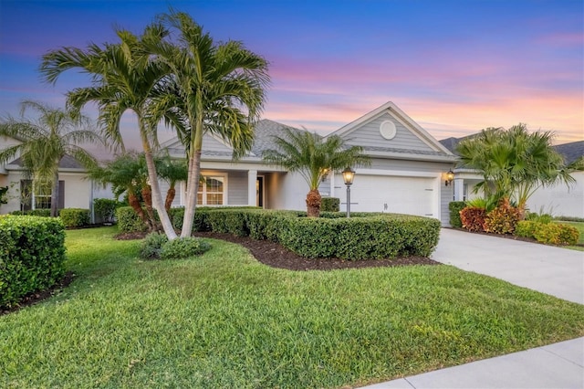 view of front of property featuring a lawn and a garage