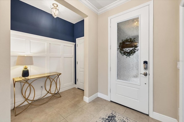 foyer with crown molding and light tile patterned flooring