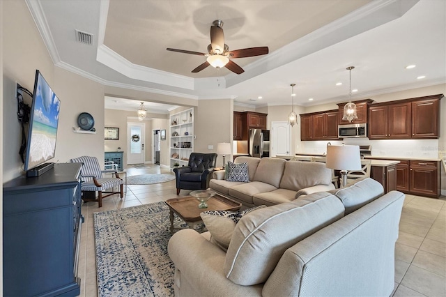 tiled living room featuring a raised ceiling, ceiling fan, and ornamental molding