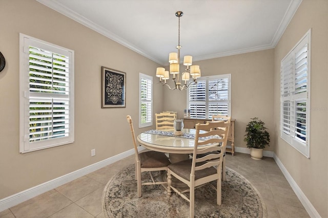 tiled dining room with a healthy amount of sunlight, ornamental molding, and an inviting chandelier