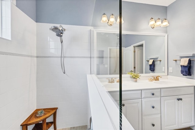 bathroom with vanity and a tile shower