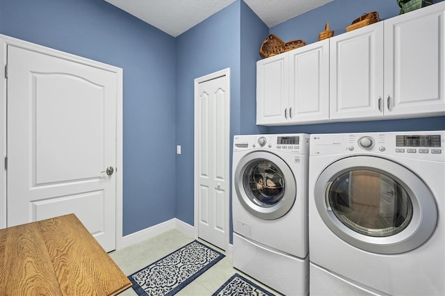 laundry room with cabinets, independent washer and dryer, a textured ceiling, and light tile patterned floors