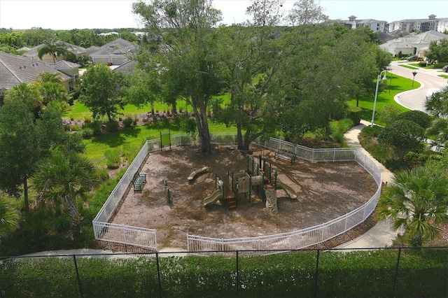 view of home's community with a playground and a yard