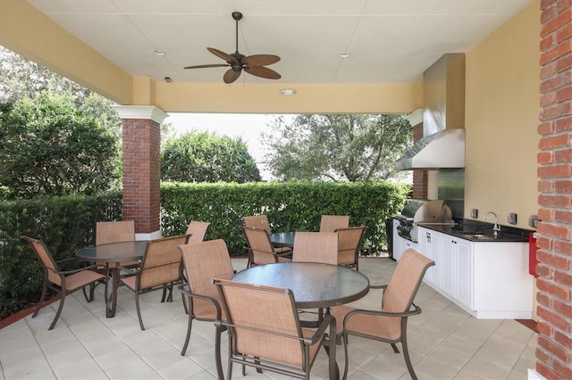 view of patio with grilling area, ceiling fan, sink, and exterior kitchen