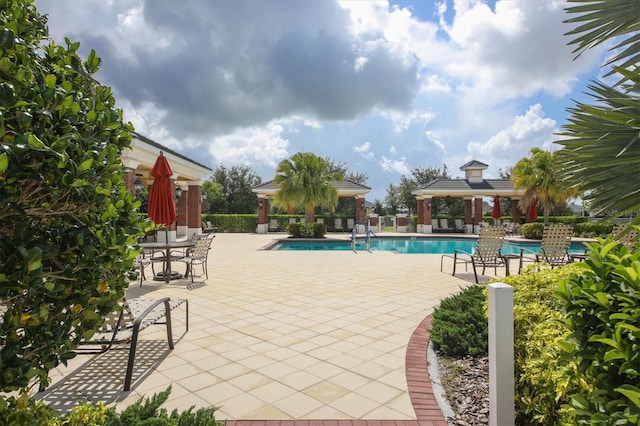 view of swimming pool featuring a gazebo and a patio