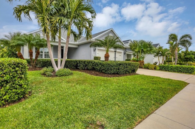 view of front facade featuring a front yard and a garage