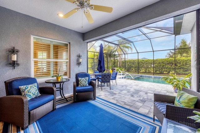 view of patio / terrace with ceiling fan and glass enclosure