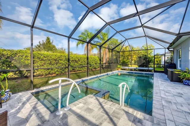 view of swimming pool with a patio area and a lanai