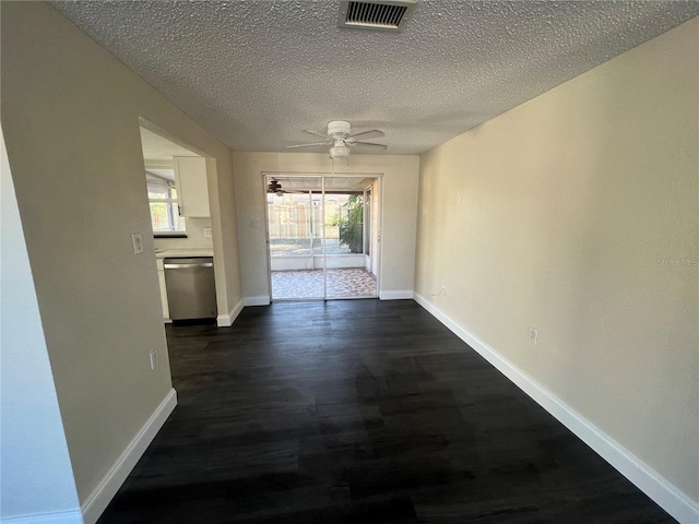 unfurnished dining area featuring ceiling fan, a healthy amount of sunlight, and a textured ceiling