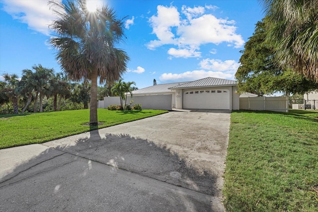 view of front of home with a front yard and a garage