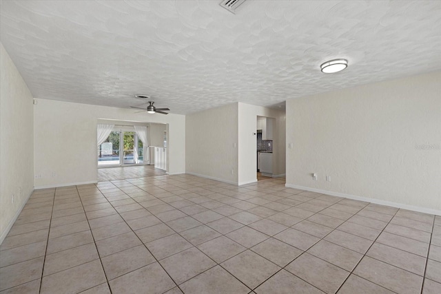 tiled spare room featuring ceiling fan and a textured ceiling