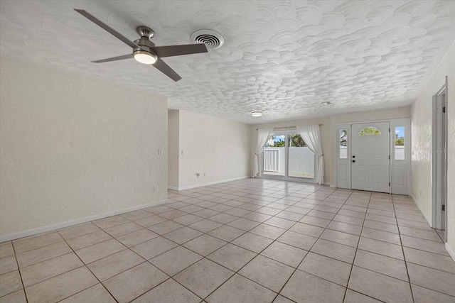 interior space with ceiling fan and light tile patterned flooring