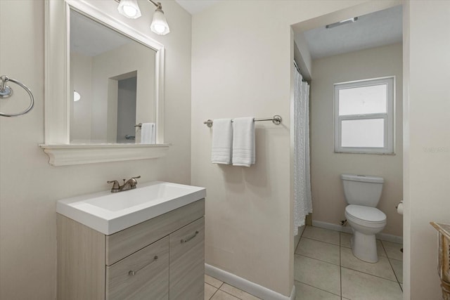 bathroom with tile patterned floors, vanity, and toilet