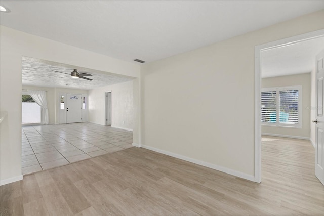 unfurnished room with ceiling fan and light hardwood / wood-style flooring