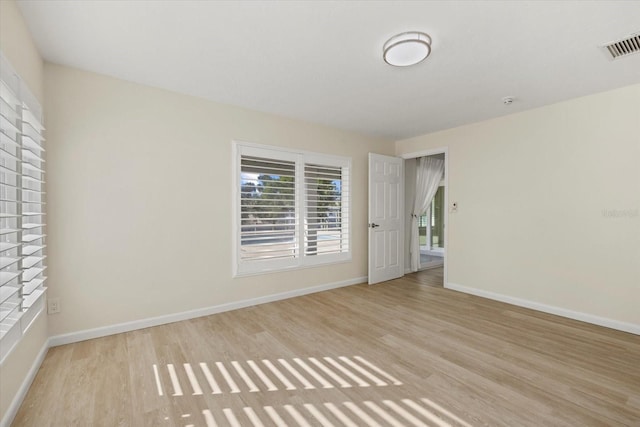 empty room with light hardwood / wood-style flooring