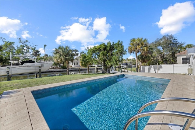 view of pool featuring a patio, a water view, and a dock