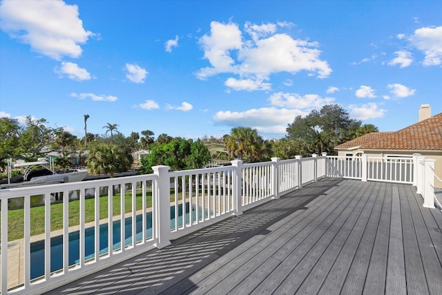 wooden deck featuring a lawn