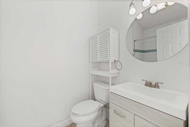 bathroom with vanity, toilet, and a shower