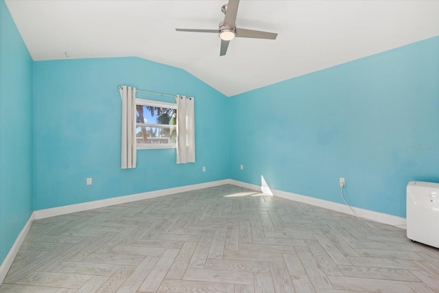 empty room featuring ceiling fan, lofted ceiling, and light parquet flooring