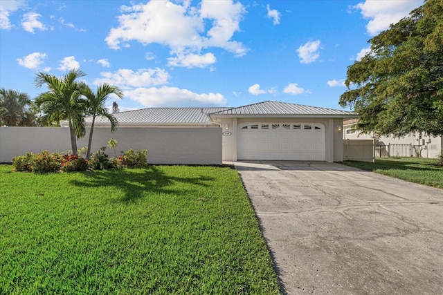 view of front of home with a front yard and a garage