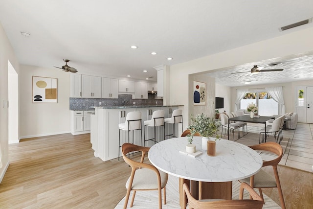 dining room with ceiling fan, light wood-style flooring, visible vents, and recessed lighting