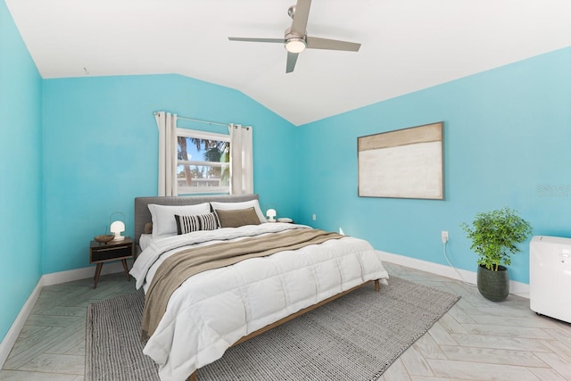 bedroom featuring lofted ceiling, a ceiling fan, and baseboards