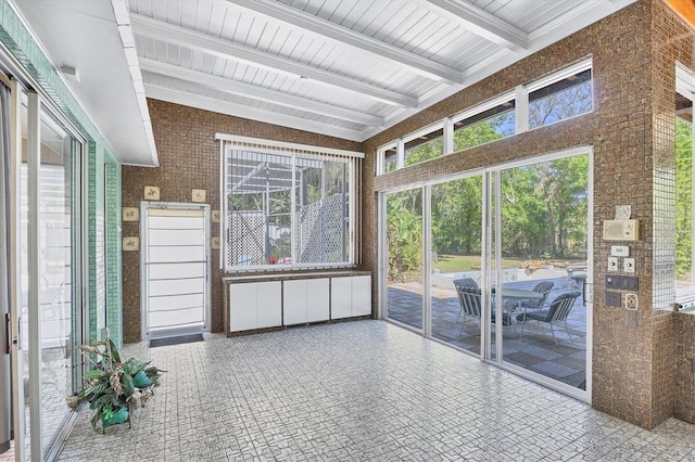 unfurnished sunroom with beam ceiling