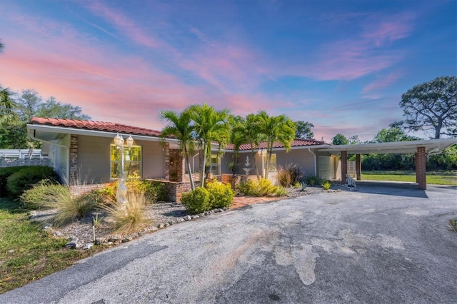 ranch-style house featuring a carport