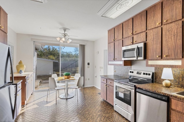 kitchen with decorative backsplash, ceiling fan, and appliances with stainless steel finishes