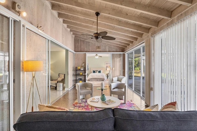 sunroom featuring ceiling fan, wooden ceiling, and vaulted ceiling with beams